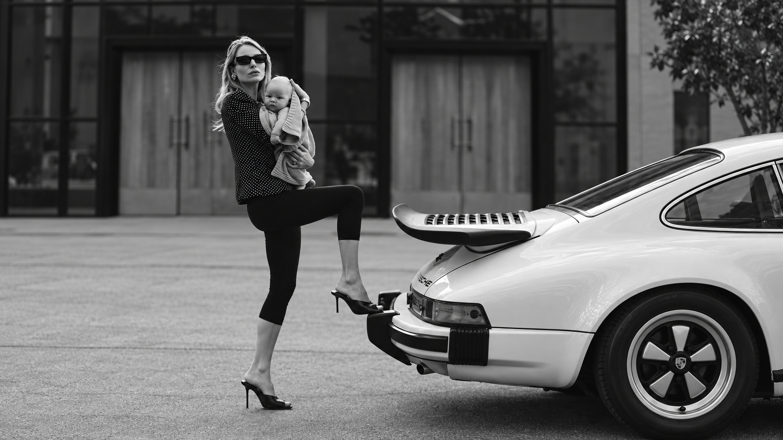 A bold mum pushing a stroller through a car park